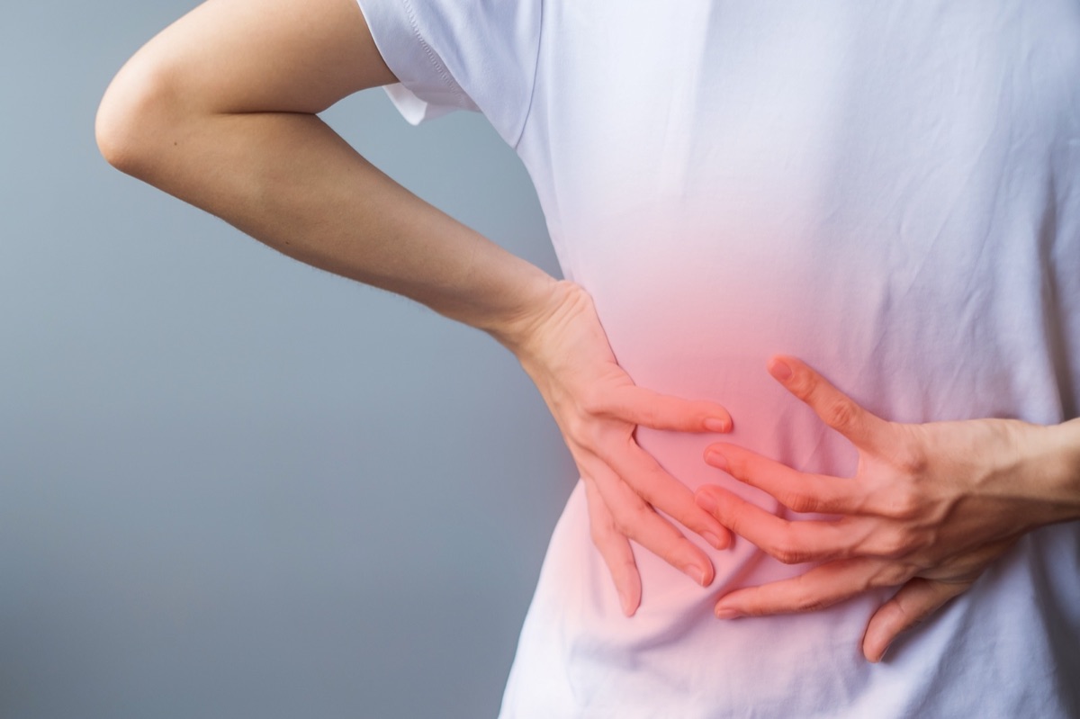 Person holding their lower back in pain